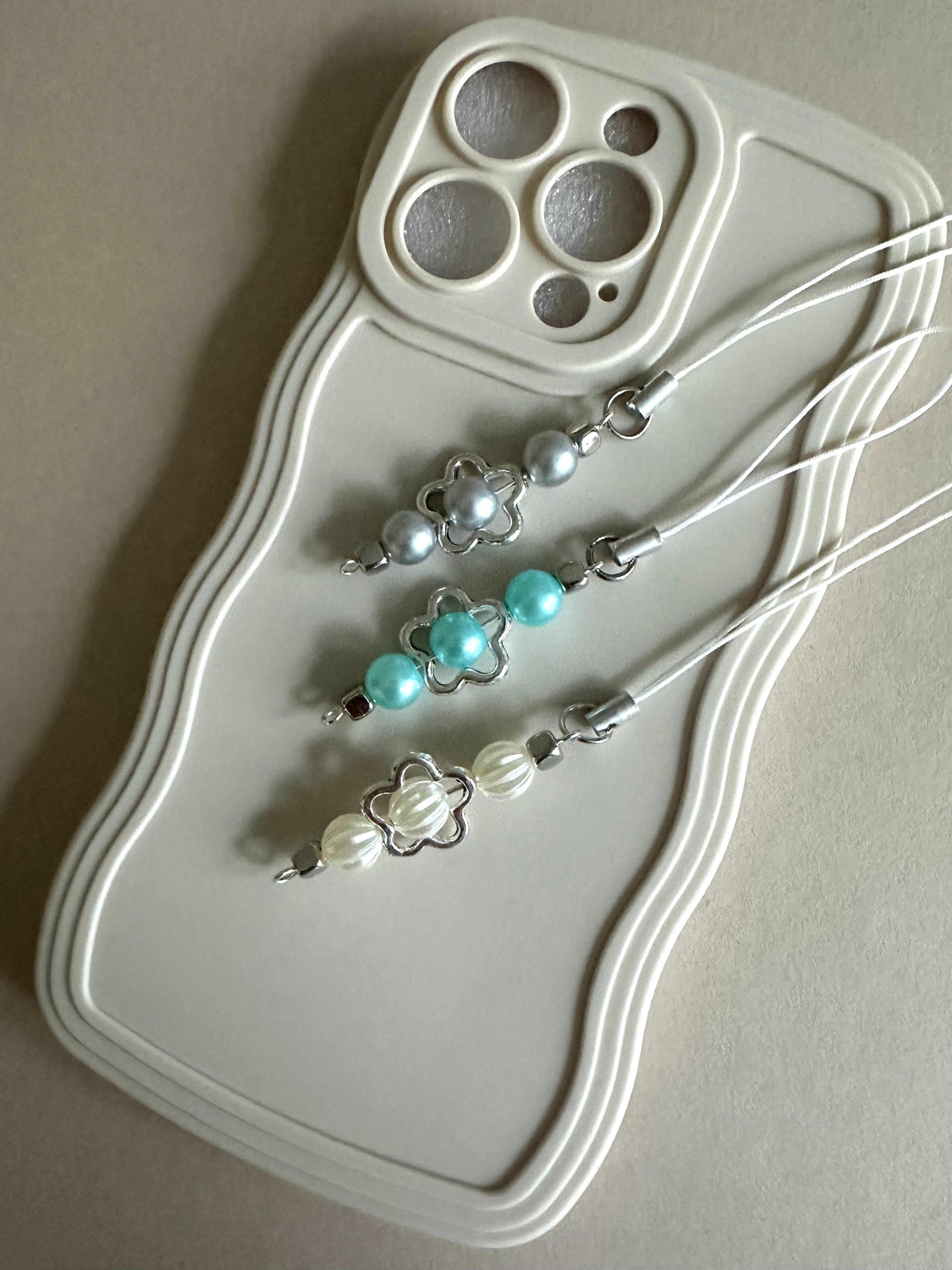 Handmade PEARL SKIES phone charm with faux pearls in ivory, baby blue, and gray, versatile for phones, AirPods, and bags
