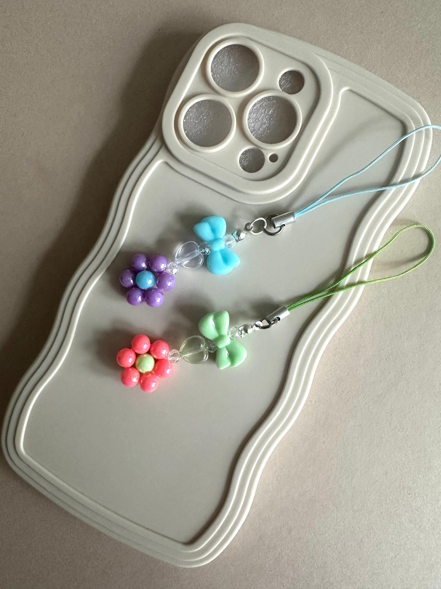 Handmade BOWL FLOWER DREAM phone charm with customizable blue or green bows, versatile accessory for phones, AirPods, keys, and bags