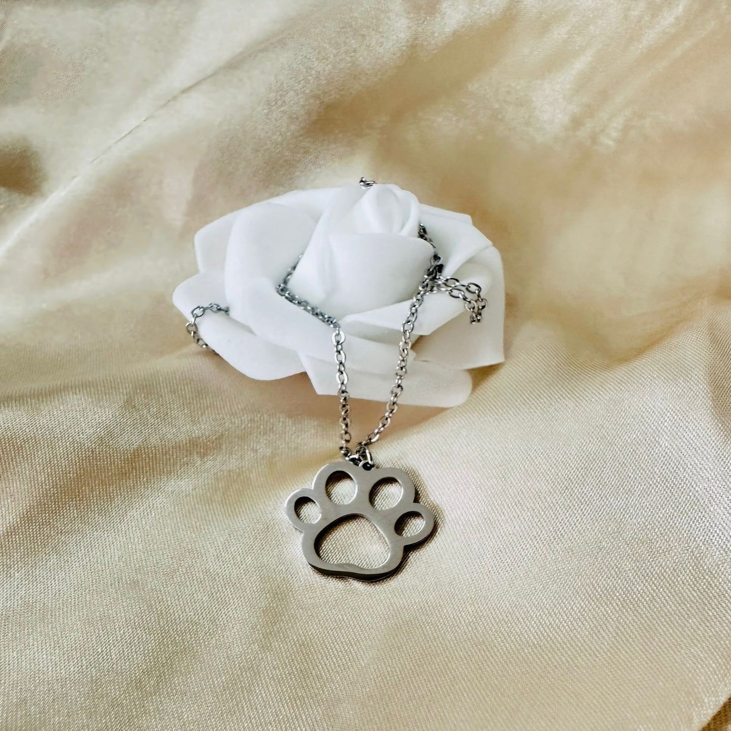 Golden stainless steel necklace with dog paw pendant on adjustable chain