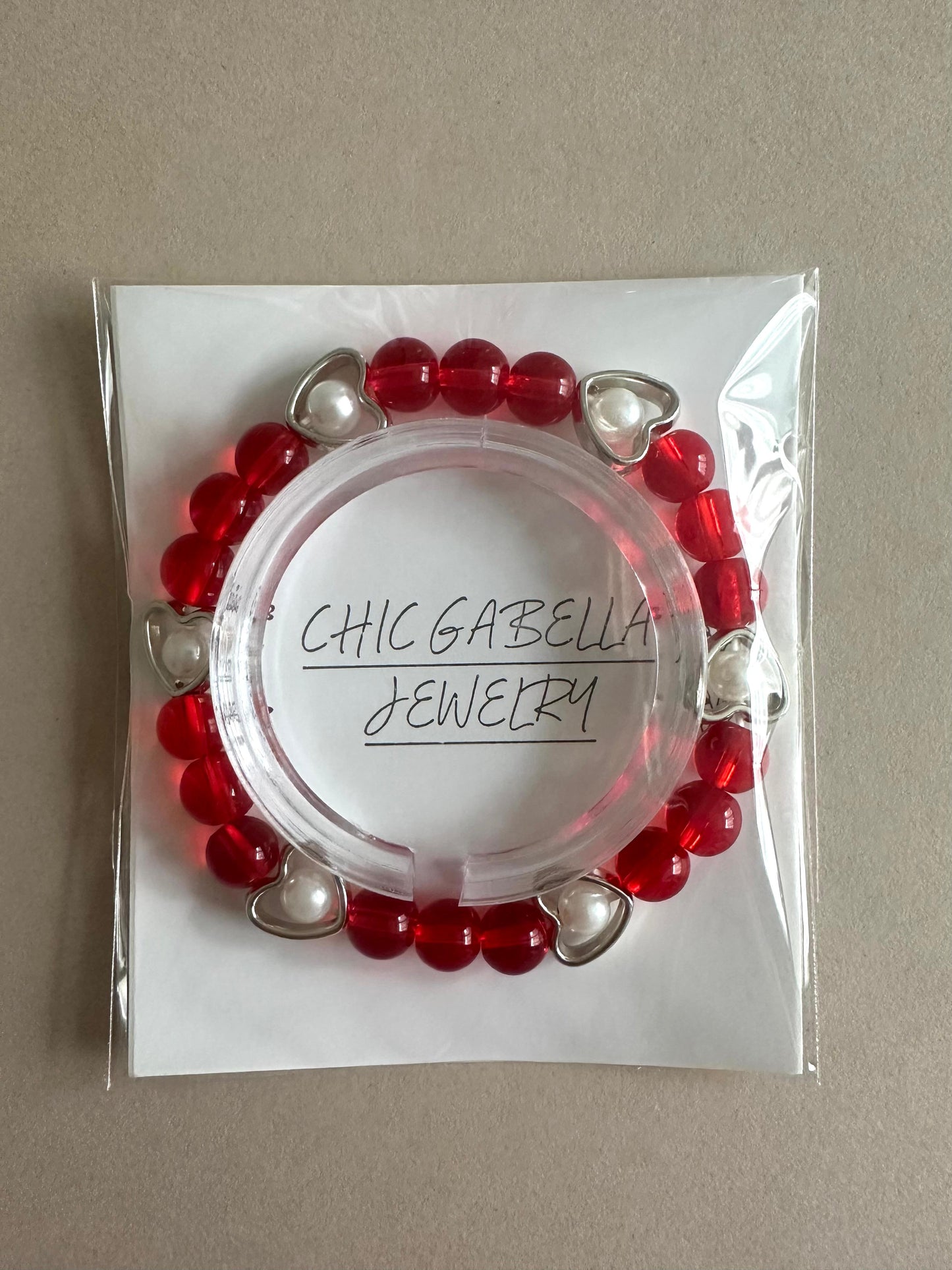 LOVE GLOW stretch bracelet with red glass beads, white faux pearls, and silver heart charm on elastic band