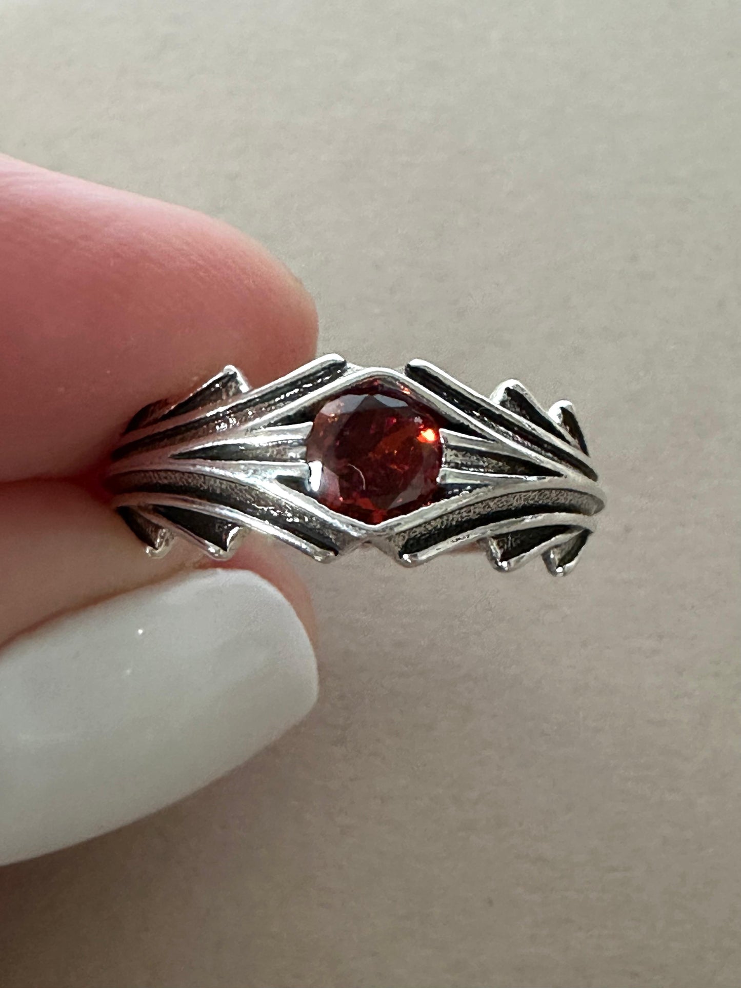 Vintage sterling silver ring with wine colored gemstone and intricate vintage design