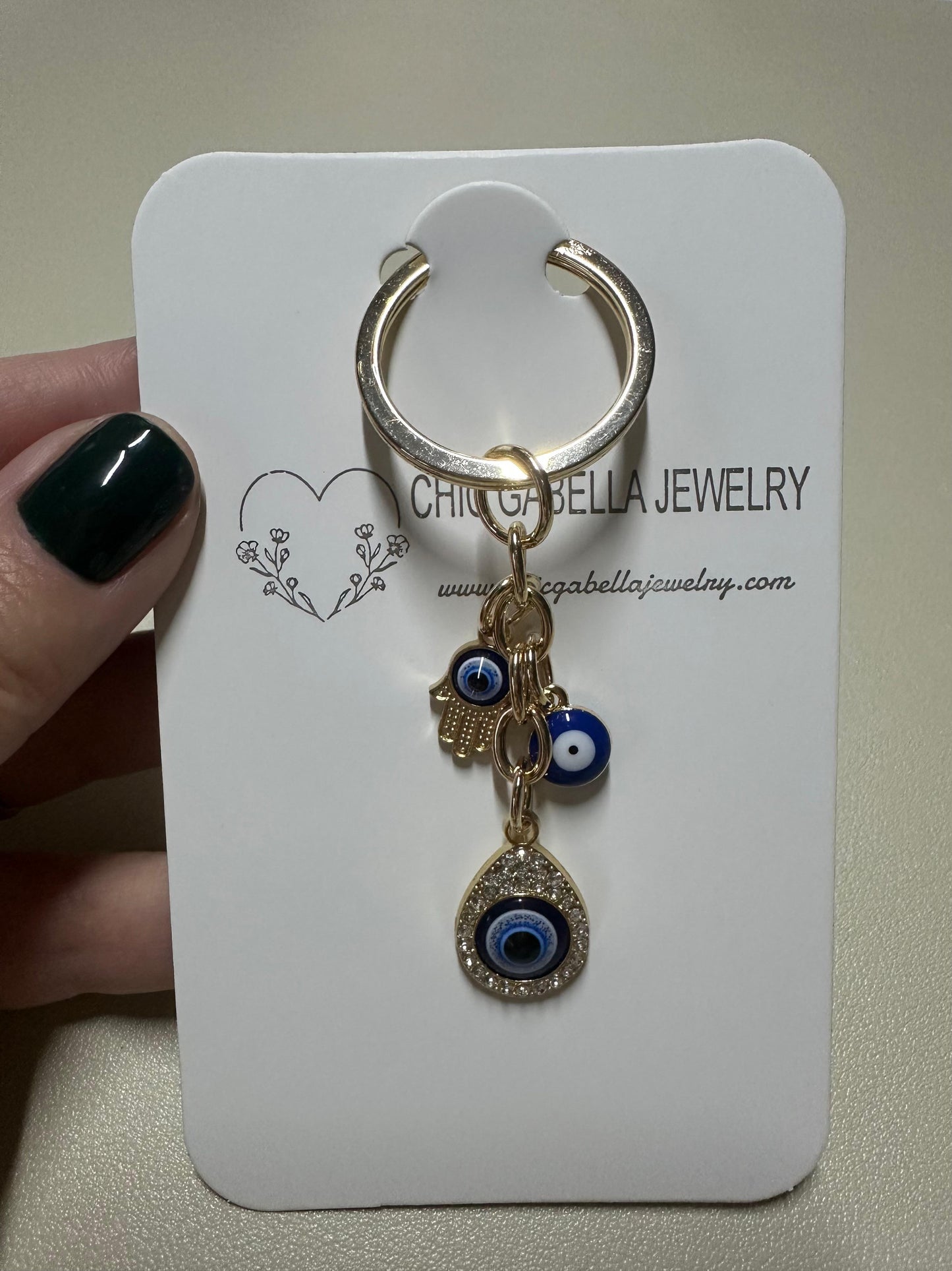 Handmade EVIL EYE golden keychain with three protective charms, 6 cm compact size, stylish and symbolic accessory