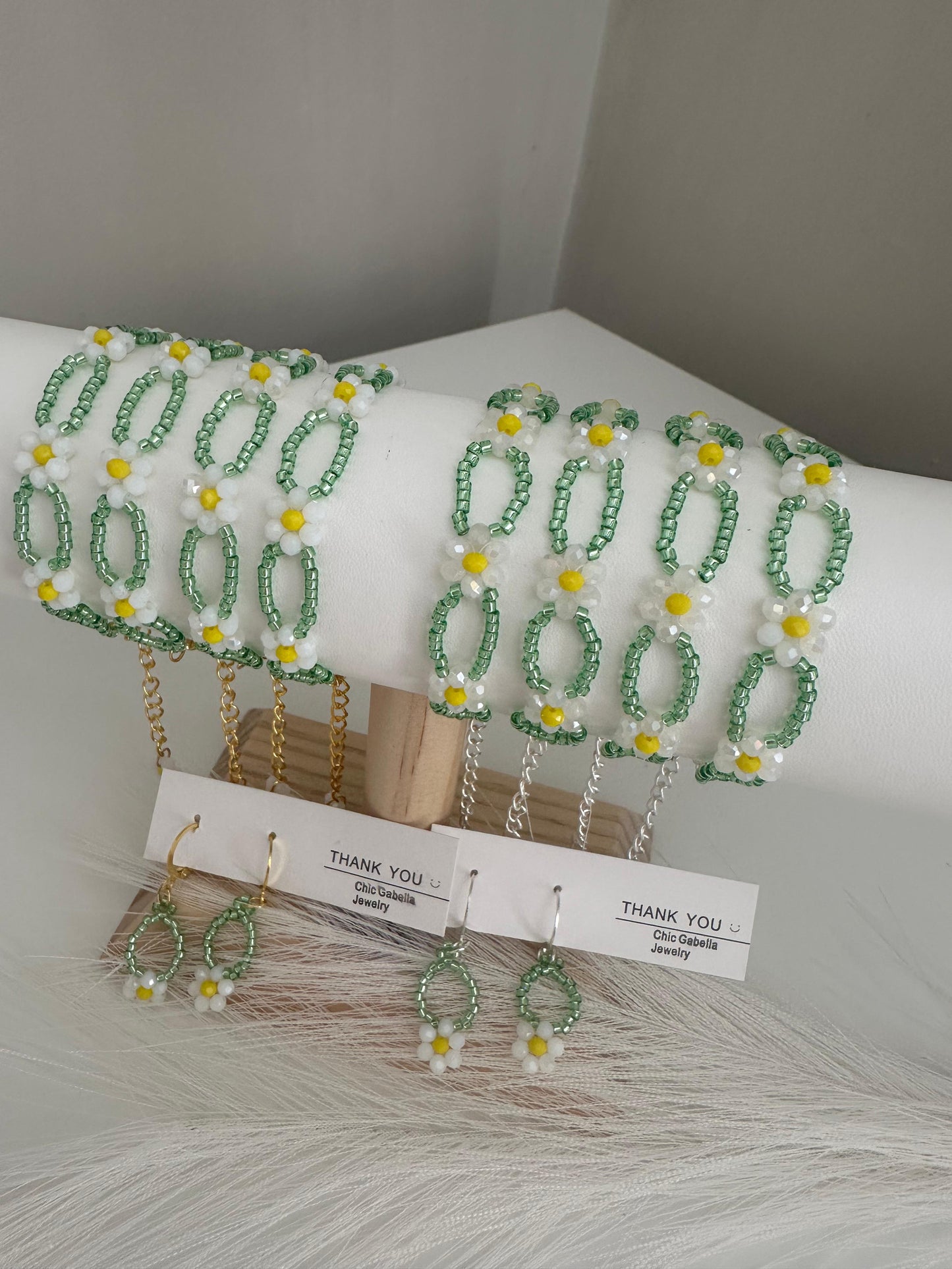 Handmade SUNNY DAISIES bracelet with gold or silver finish, featuring white, yellow, and green beads