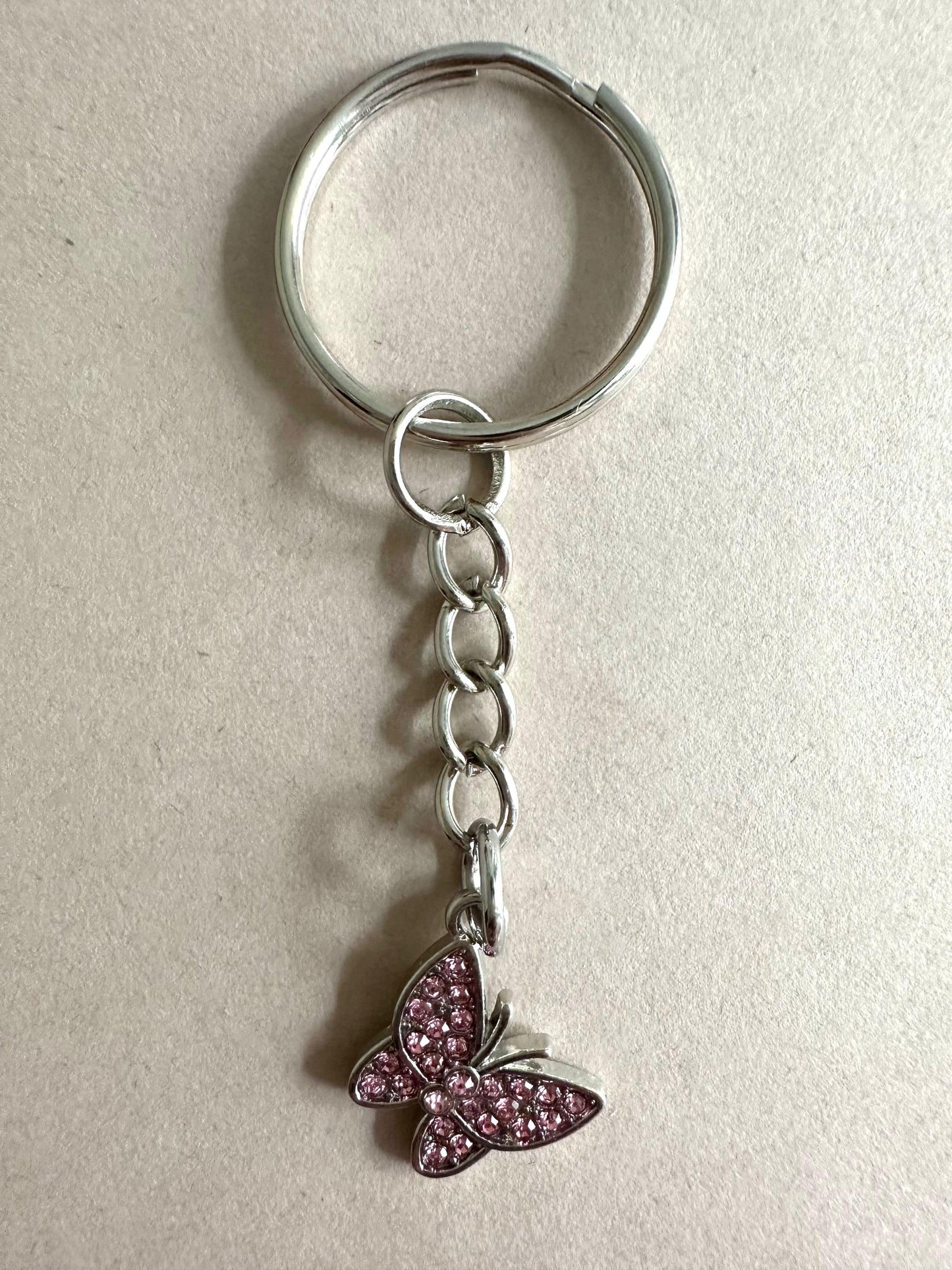 Silver butterfly keychain with blue rhinestones and golden clasp, handmade elegant accessory
