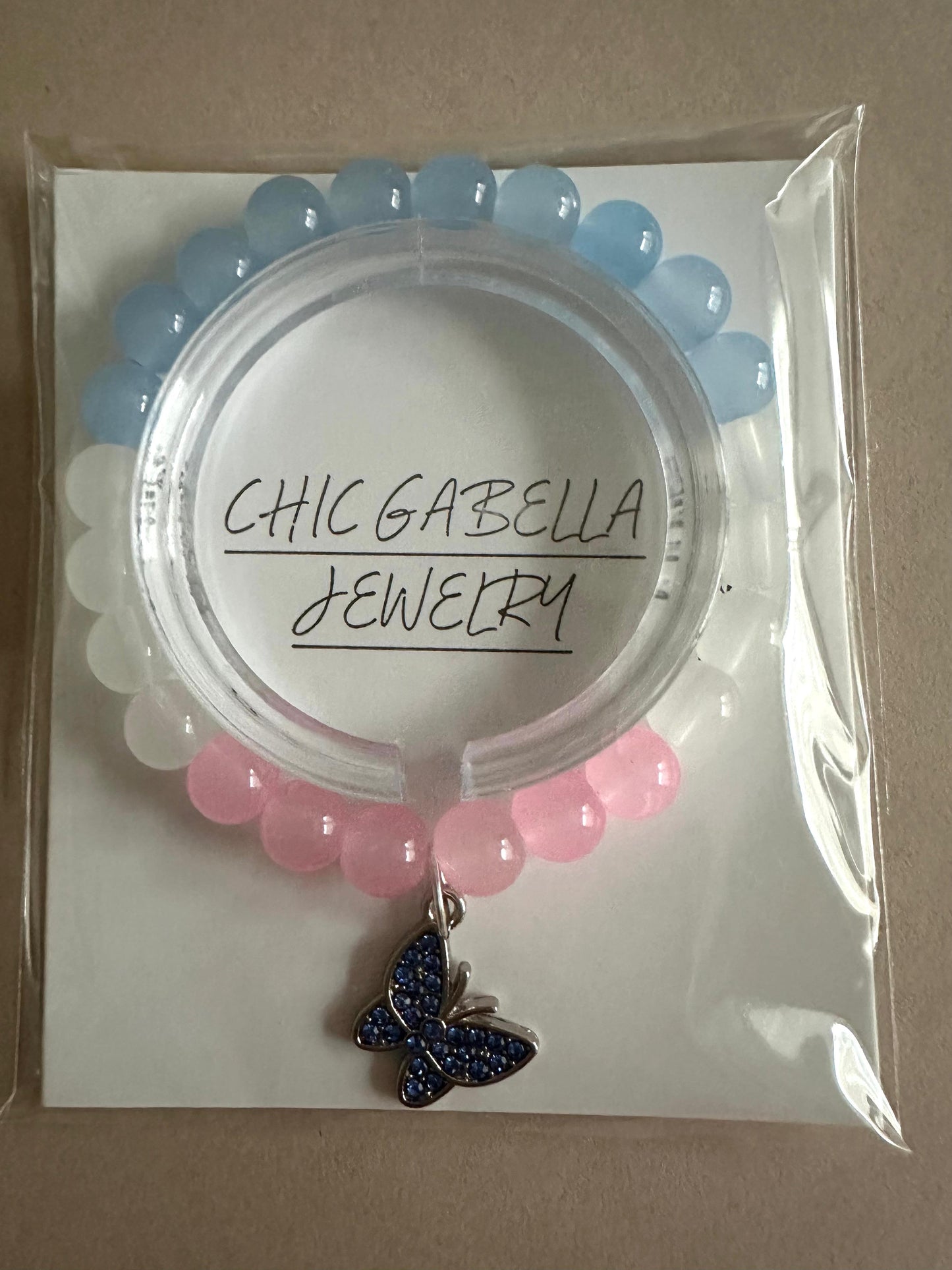 Elegant butterfly stretch bracelet with pink and blue glass beads and silver charm