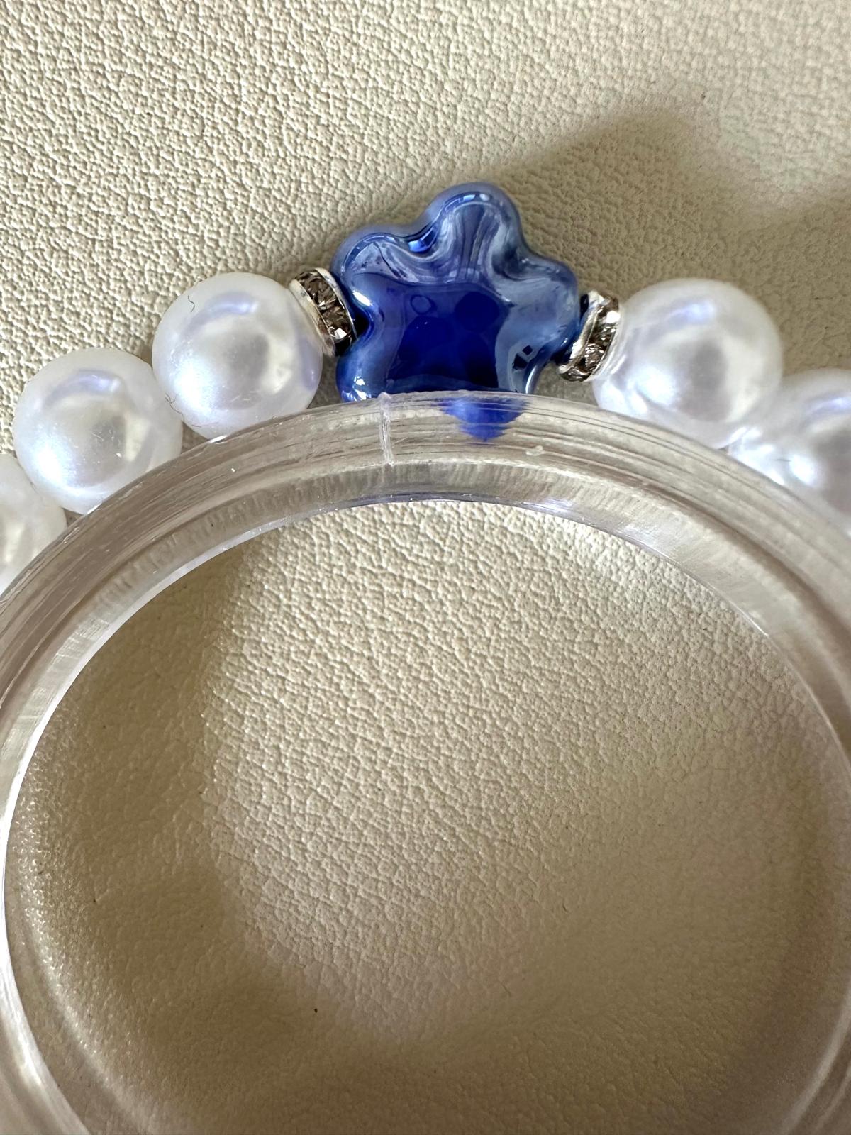 Dreamy pearl garland stretch bracelet with white faux pearls, silver rhinestone spacers, and blue flower bead