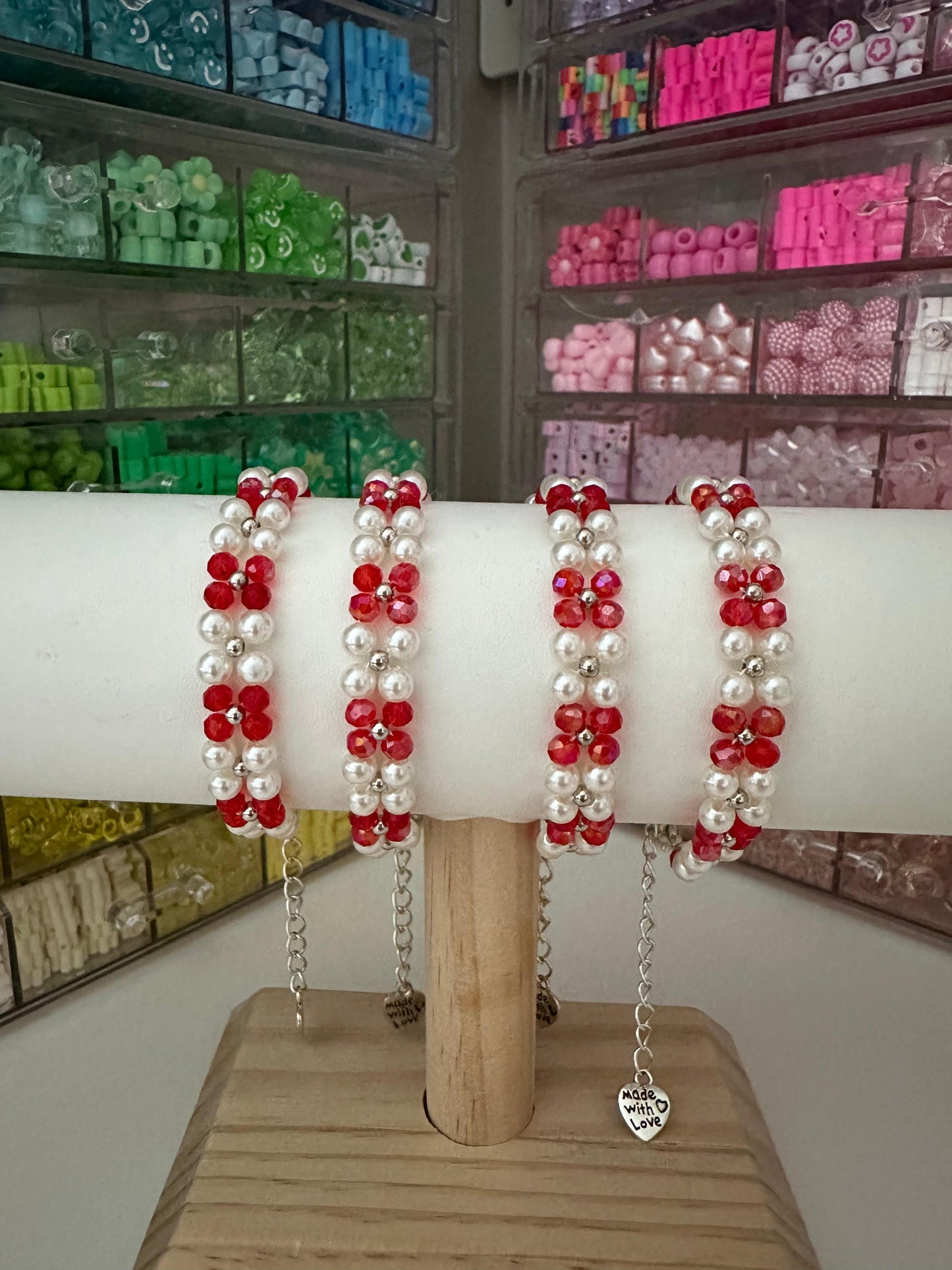 Handmade bracelet with red crystal beads, ivory faux pearls, and silver accents on stainless steel chain