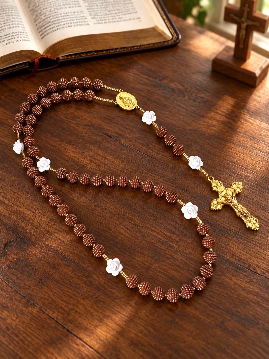 Cocoa Grace Handmade Rosary with textured brown beads, white rose-shaped accents, and a gold-tone medallion and crucifix.