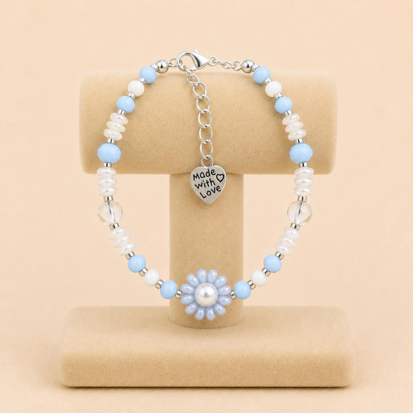 Ocean Mist handmade bracelet with light blue and white glass beads, faux pearl, and handwoven flower design