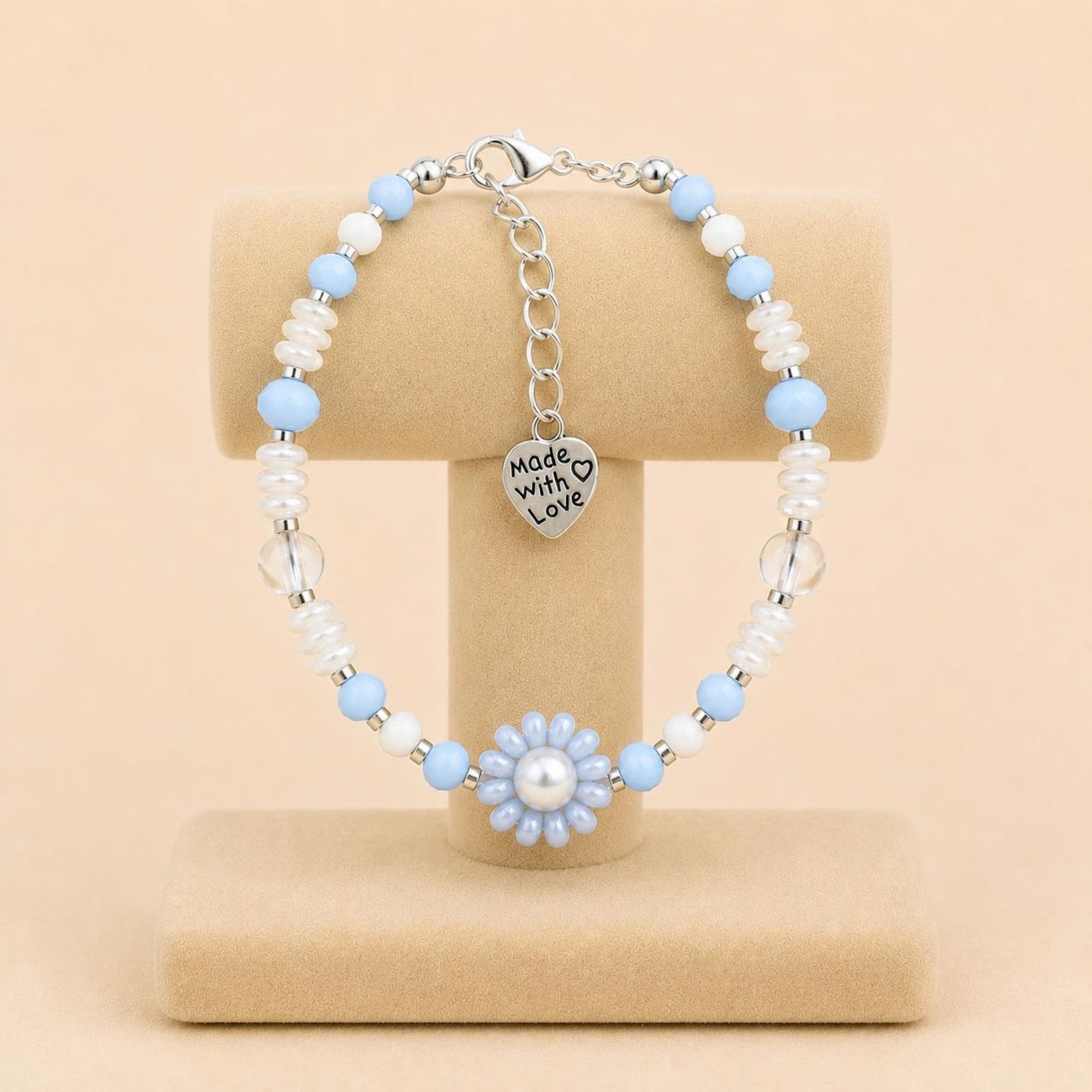 Ocean Mist handmade bracelet with light blue and white glass beads, faux pearl, and handwoven flower design