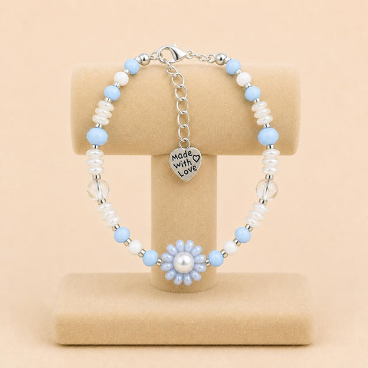 Ocean Mist handmade bracelet with light blue and white glass beads, faux pearl, and handwoven flower design