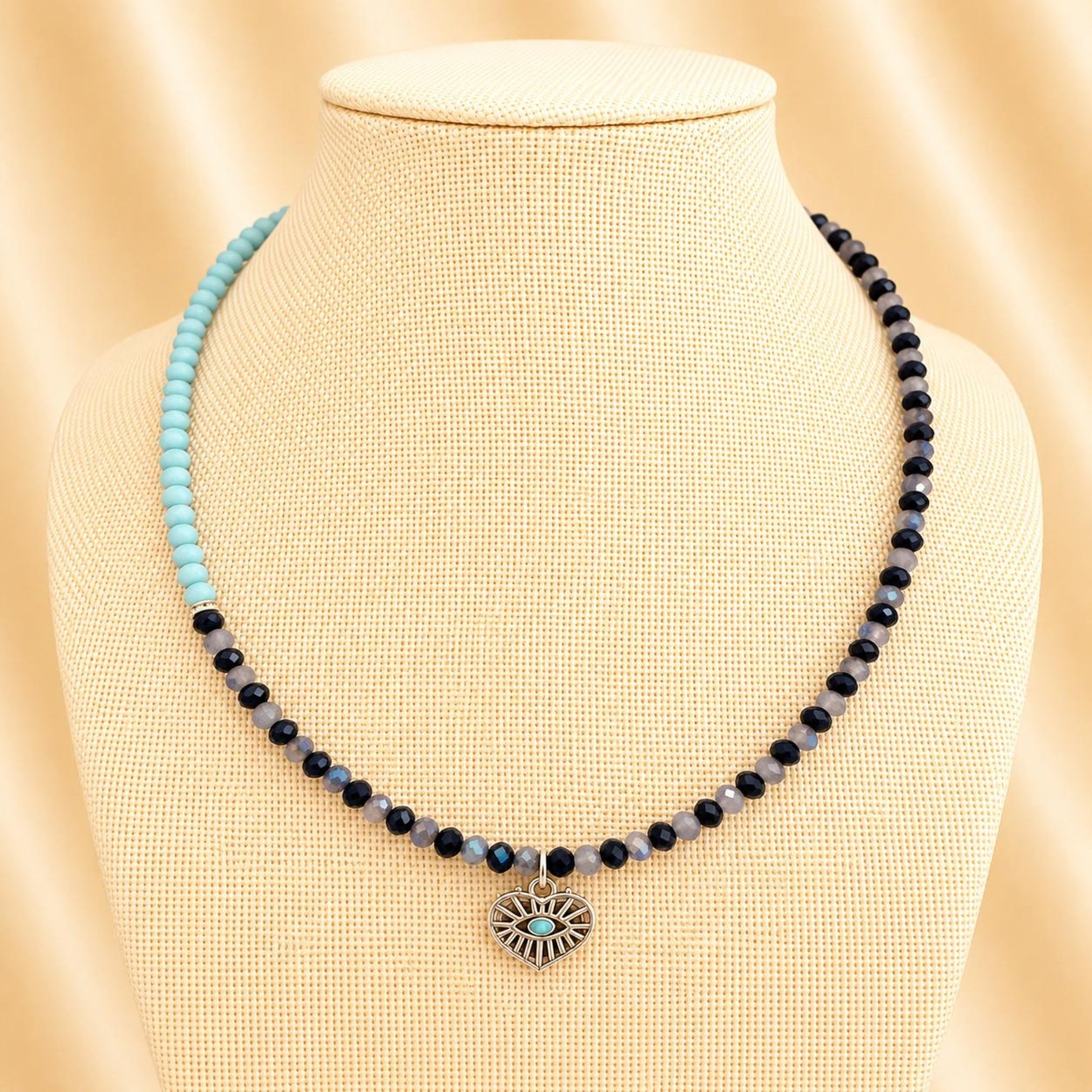 Handmade Oceanic Opulence necklace with blue glass beads, silver rhinestones, and heart pendant