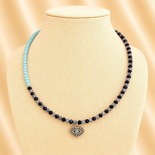 Handmade Oceanic Opulence necklace with blue glass beads, silver rhinestones, and heart pendant