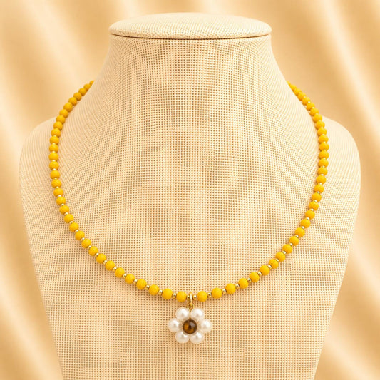 Handmade necklace with yellow glass beads and pearl flower pendant on silver chain