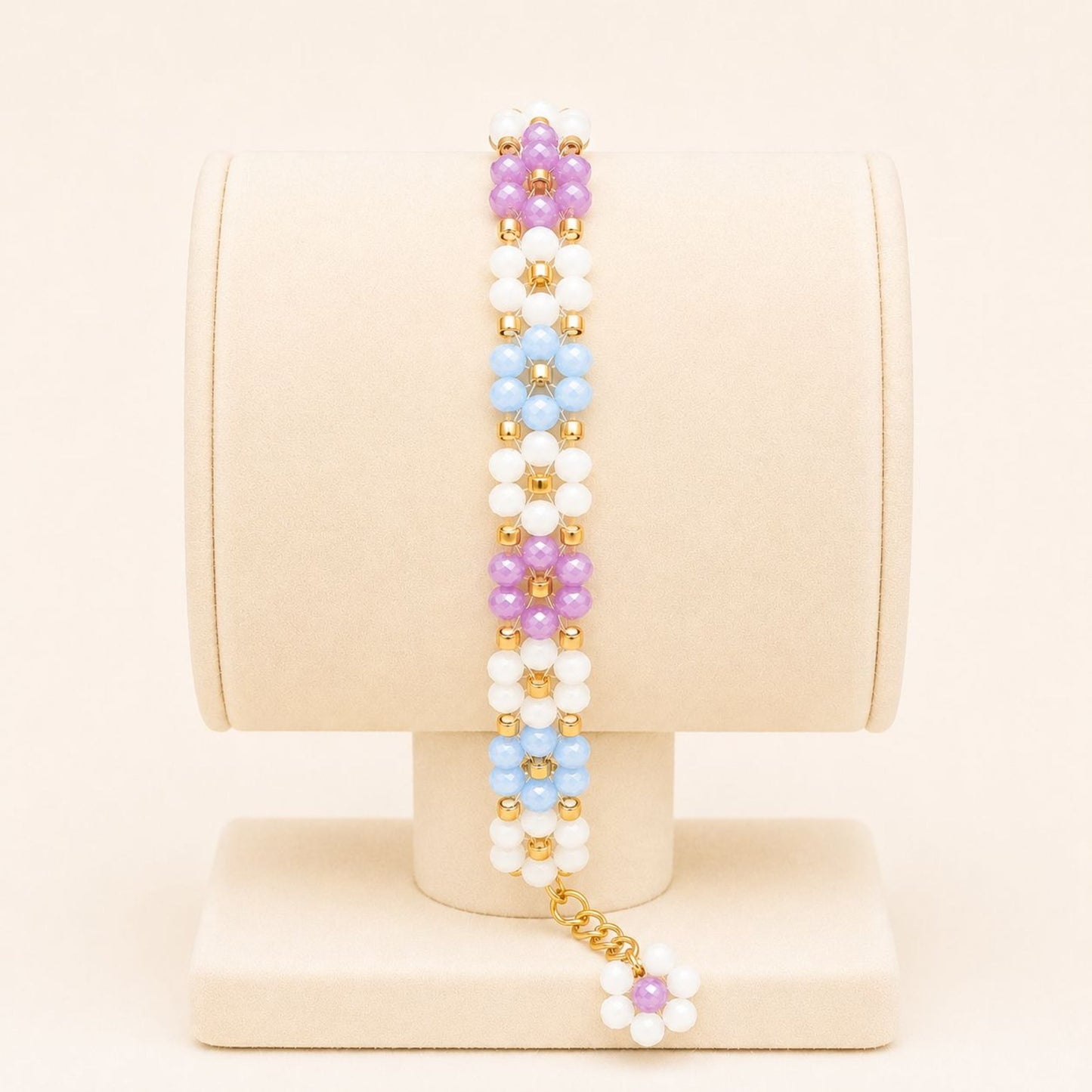 Colorful handmade bracelet with white, blue, mauve glass beads and 18K gold-plated clasp on nylon string