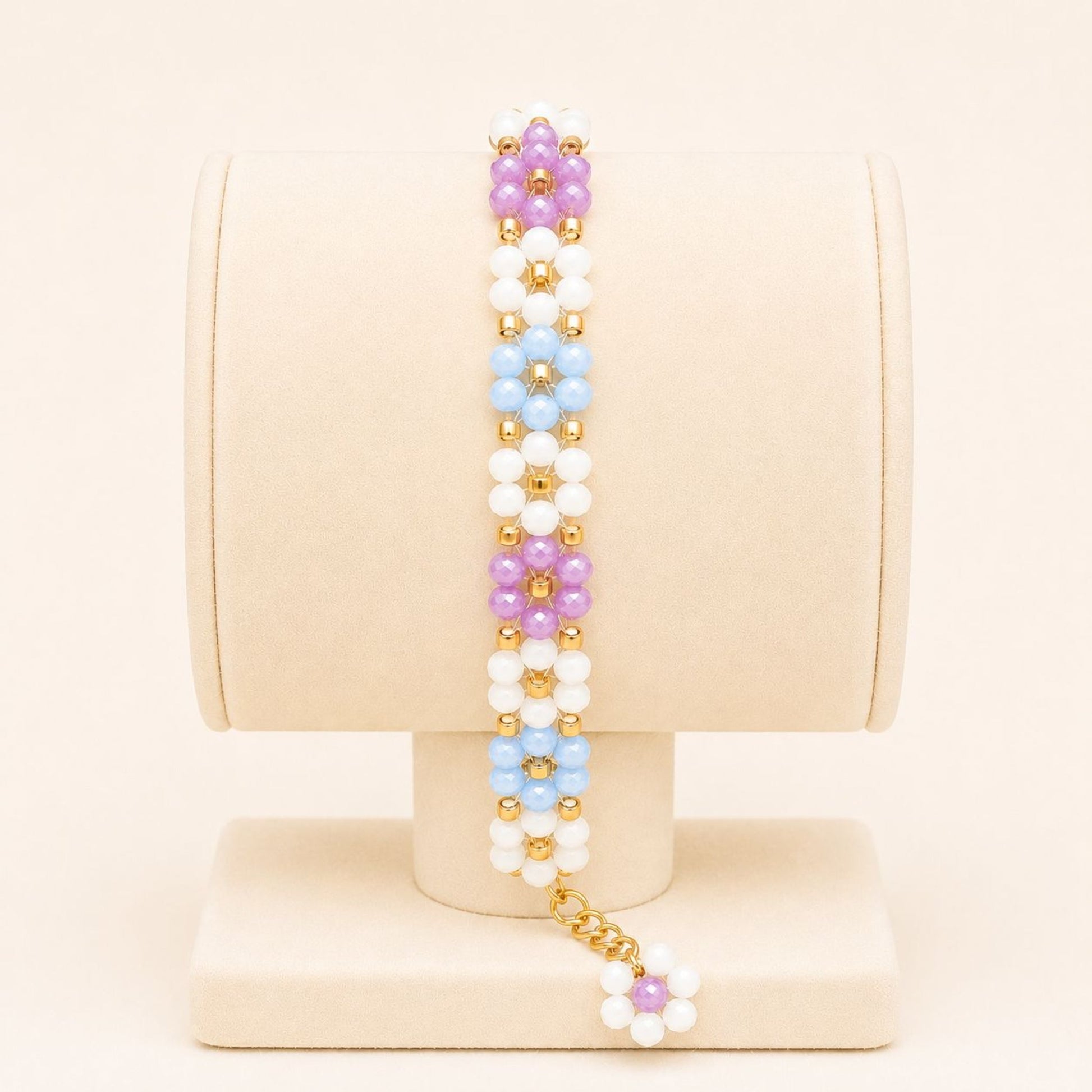 Colorful handmade bracelet with white, blue, mauve glass beads and 18K gold-plated clasp on nylon string