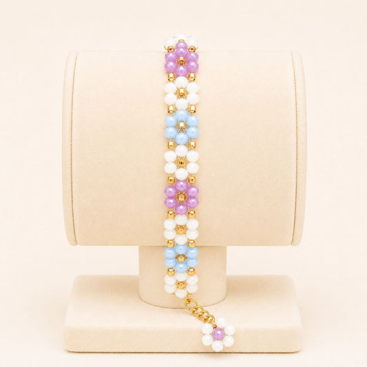 Colorful handmade bracelet with white, blue, mauve glass beads and 18K gold-plated clasp on nylon string