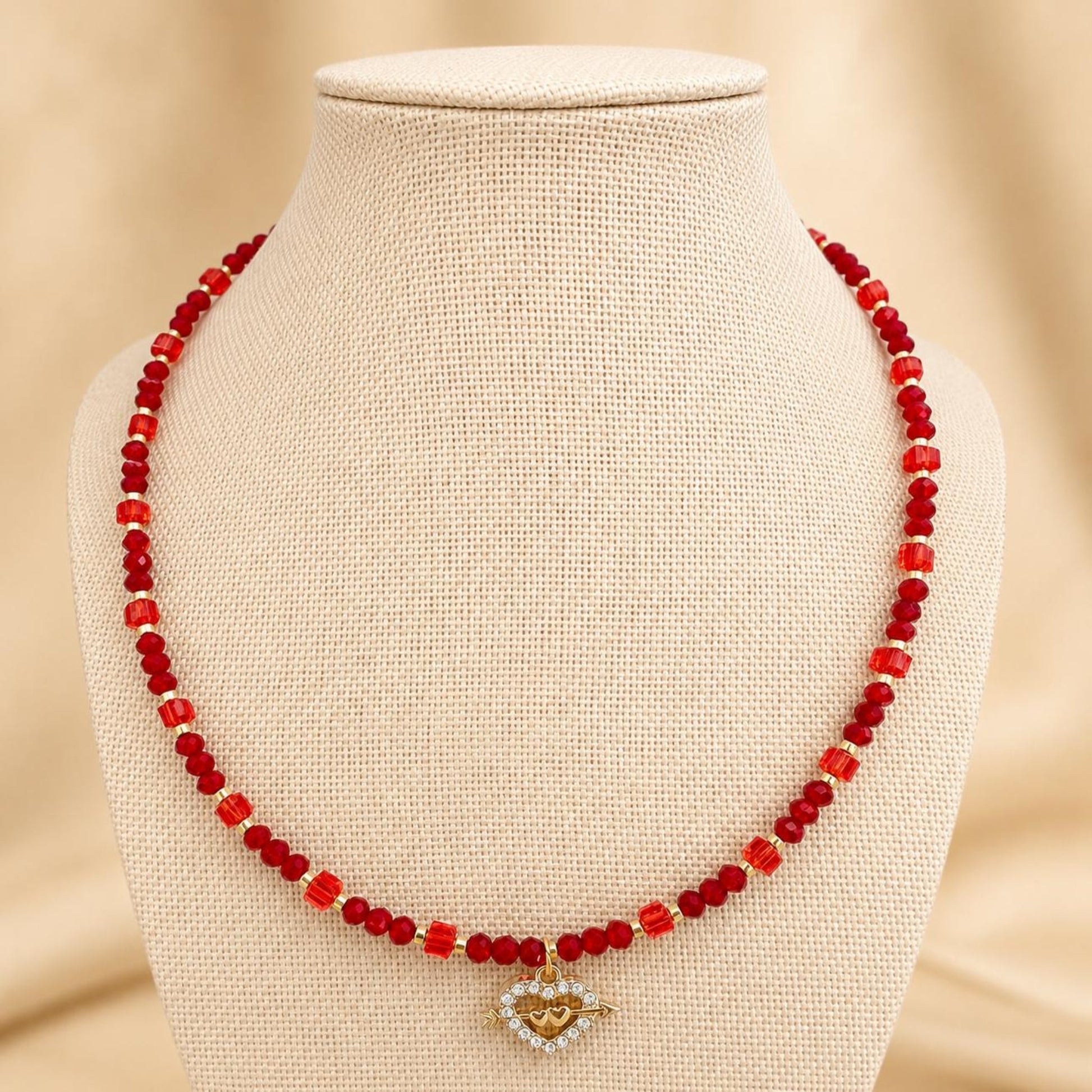Handmade AALIYAH LOVE necklace with red crystal beads and gold heart pendant on gold-plated chain