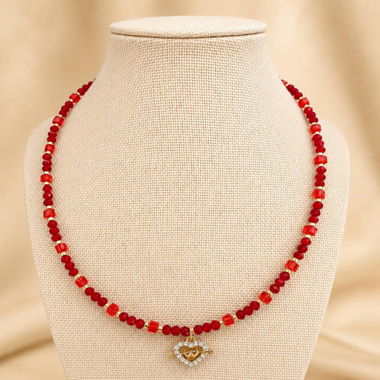 Handmade AALIYAH LOVE necklace with red crystal beads and gold heart pendant on gold-plated chain