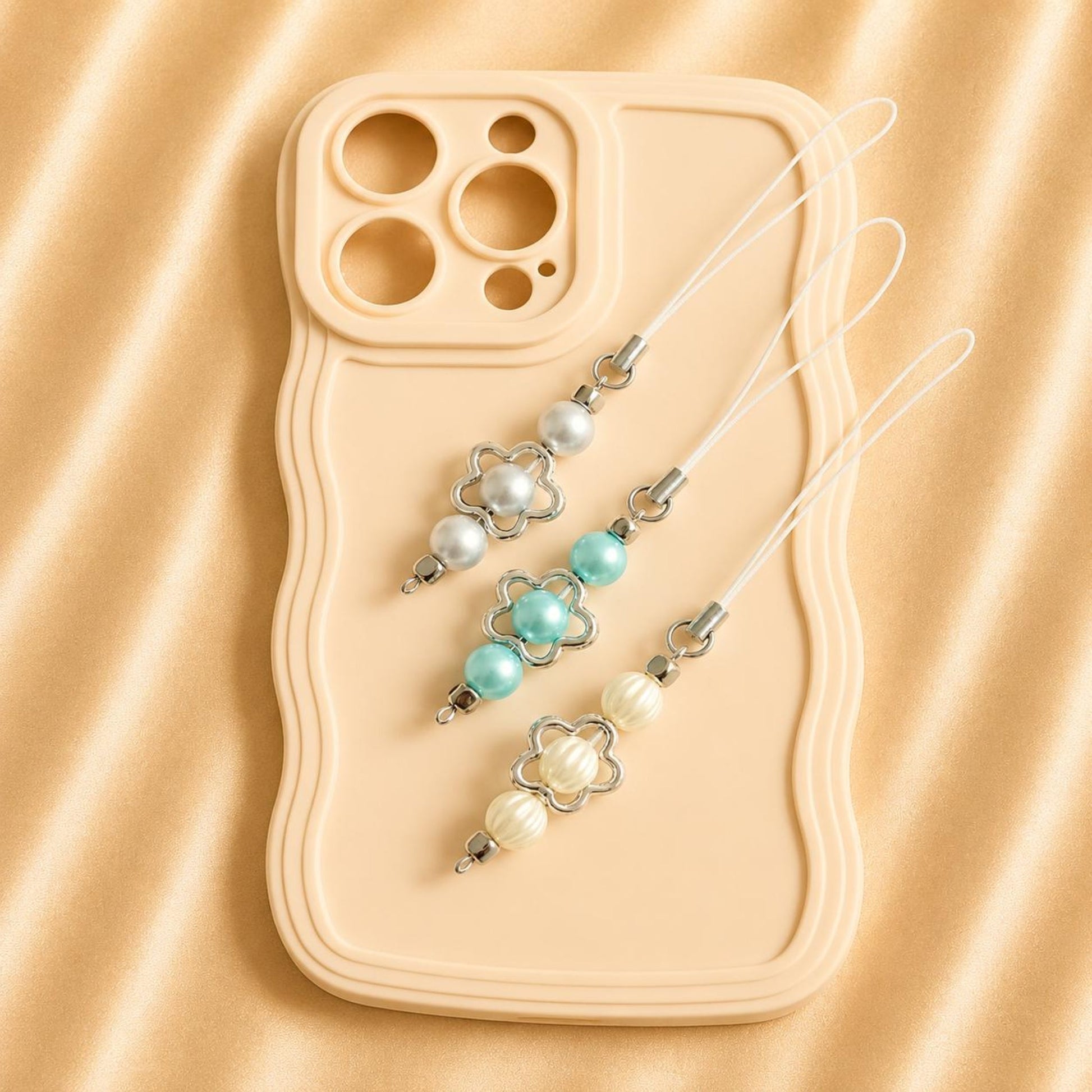 Handmade PEARL SKIES phone charm with customizable faux pearls in ivory, baby blue, and gray designs