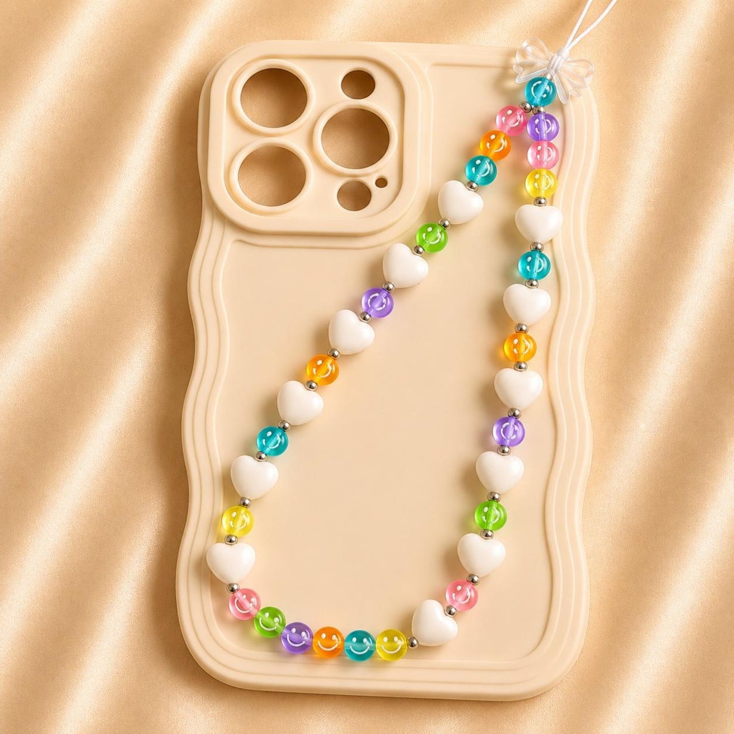 Colorful handmade phone charm with beads and heart design attached to phone case