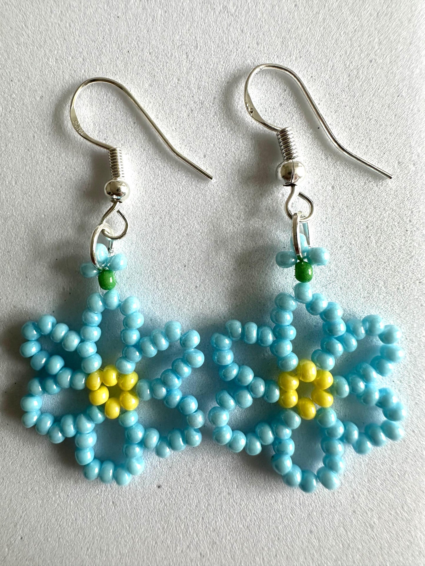 DAISY BLOOM silver earrings with delicate handmade daisy flower design in white and sky blue colors