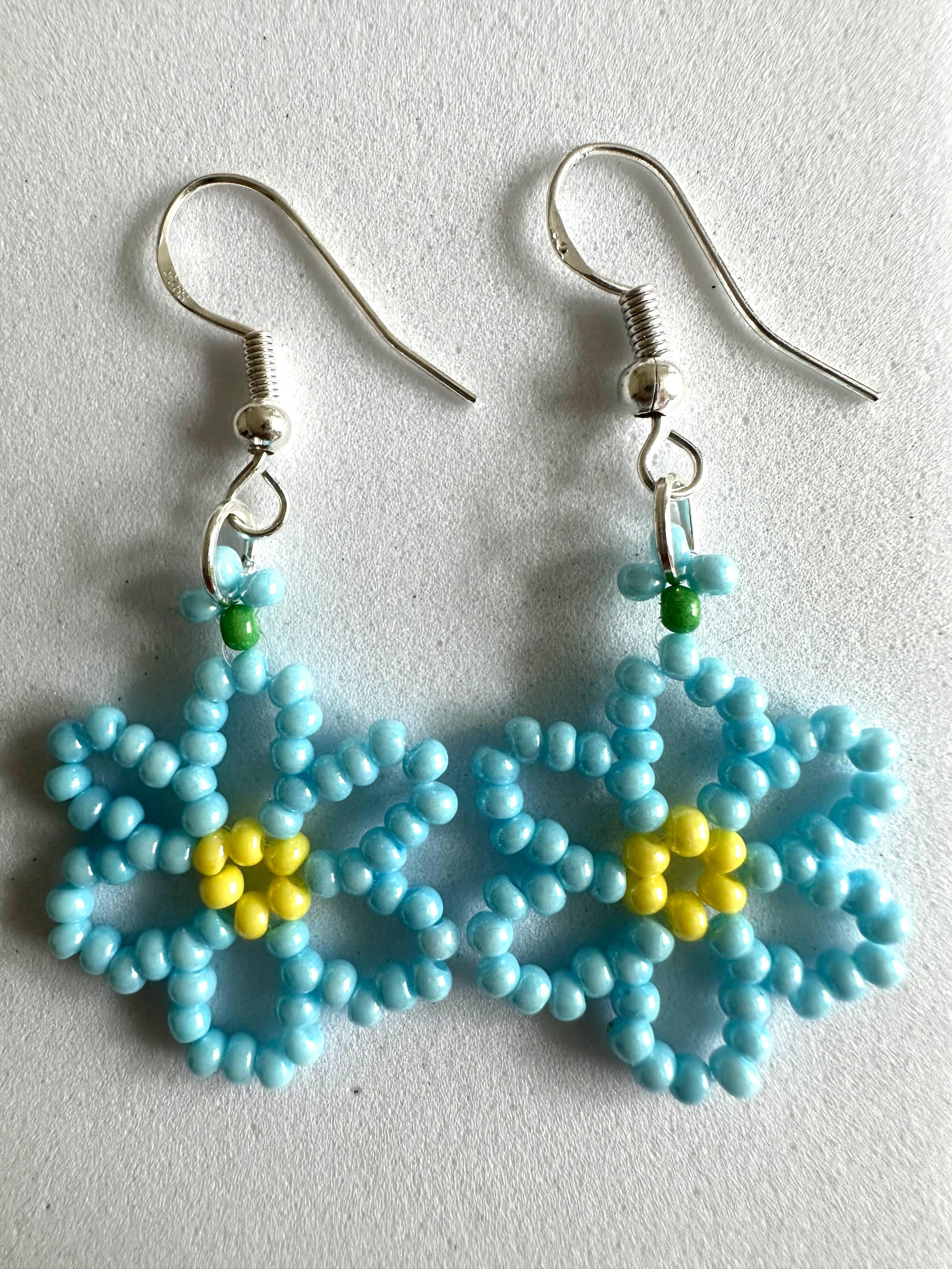 DAISY BLOOM silver earrings with delicate handmade daisy flower design in white and sky blue colors