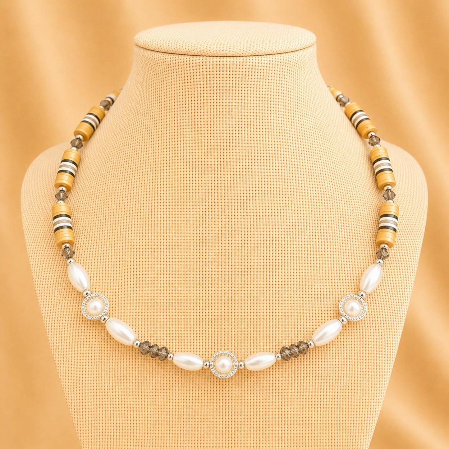 Handmade necklace with ivory faux pearls, grey crystal beads, and silver accents, elegant and adjustable length.