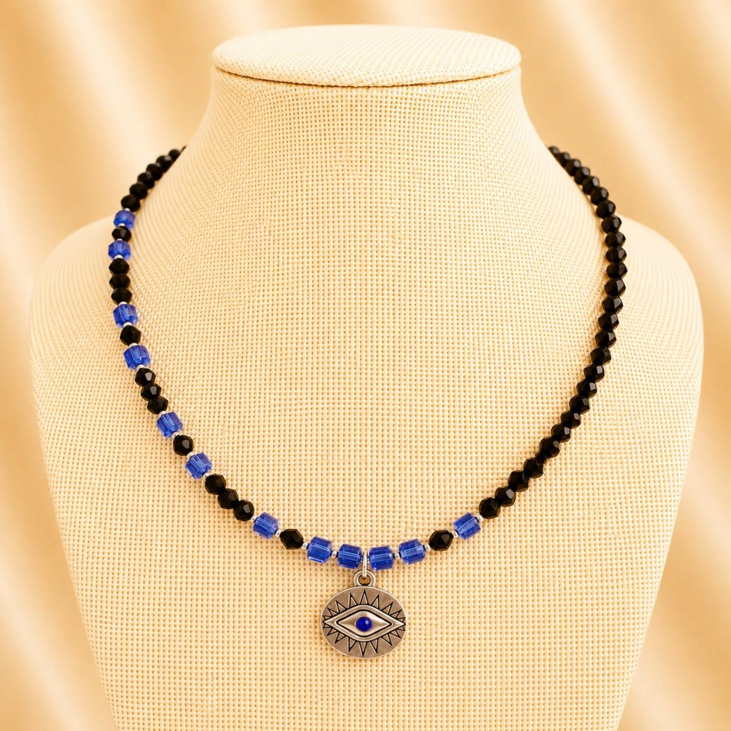Handmade necklace with black and indigo crystal beads and silver accents on nylon string