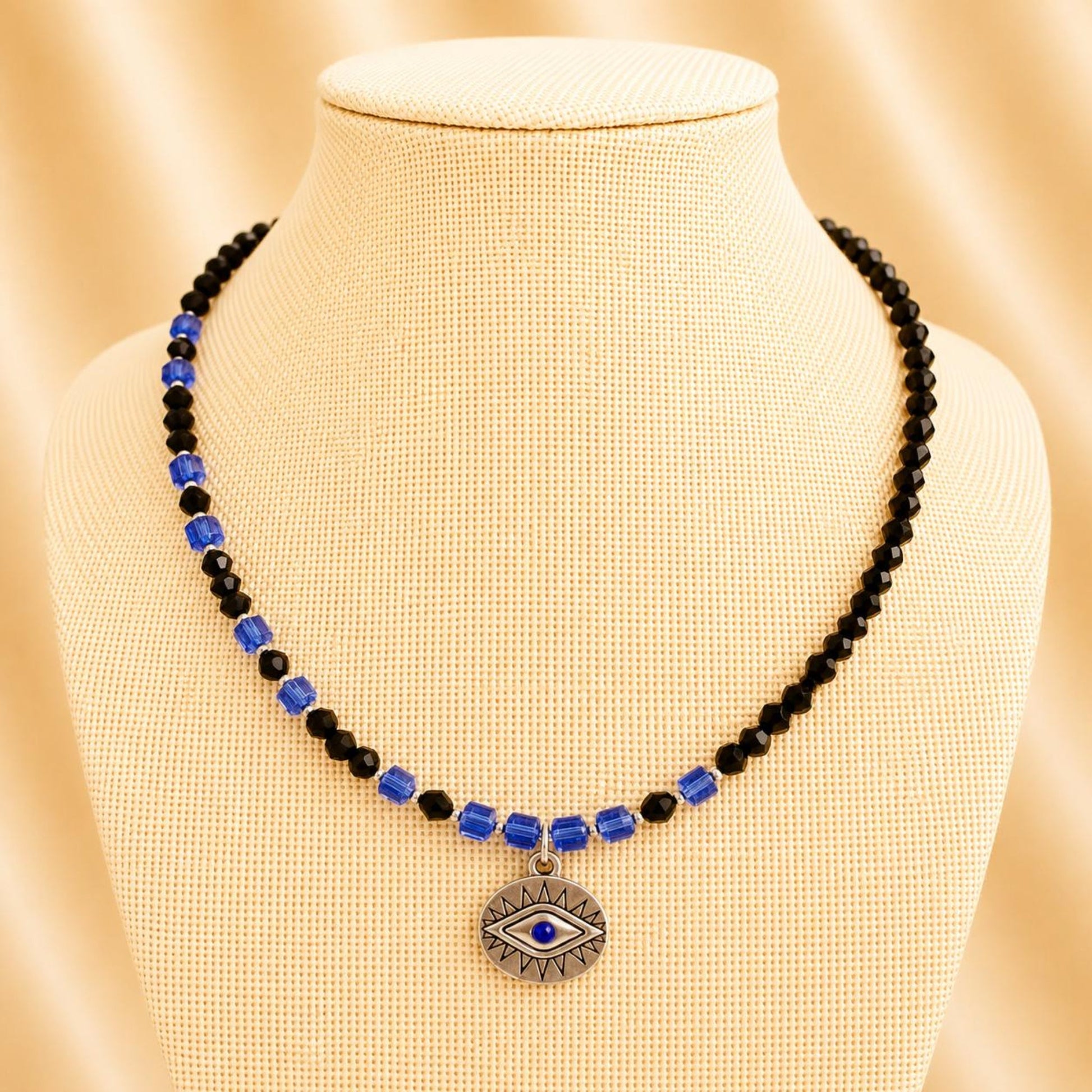 Handmade necklace with black and indigo crystal beads and silver accents on nylon string