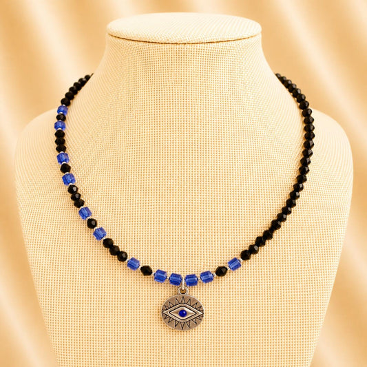 Handmade necklace with black and indigo crystal beads and silver accents on nylon string