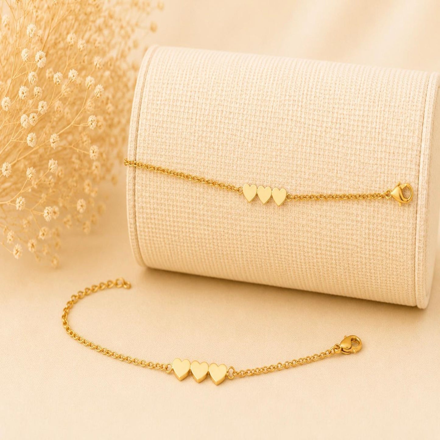 Elegant stainless steel bracelet with three 18K gold-plated hearts