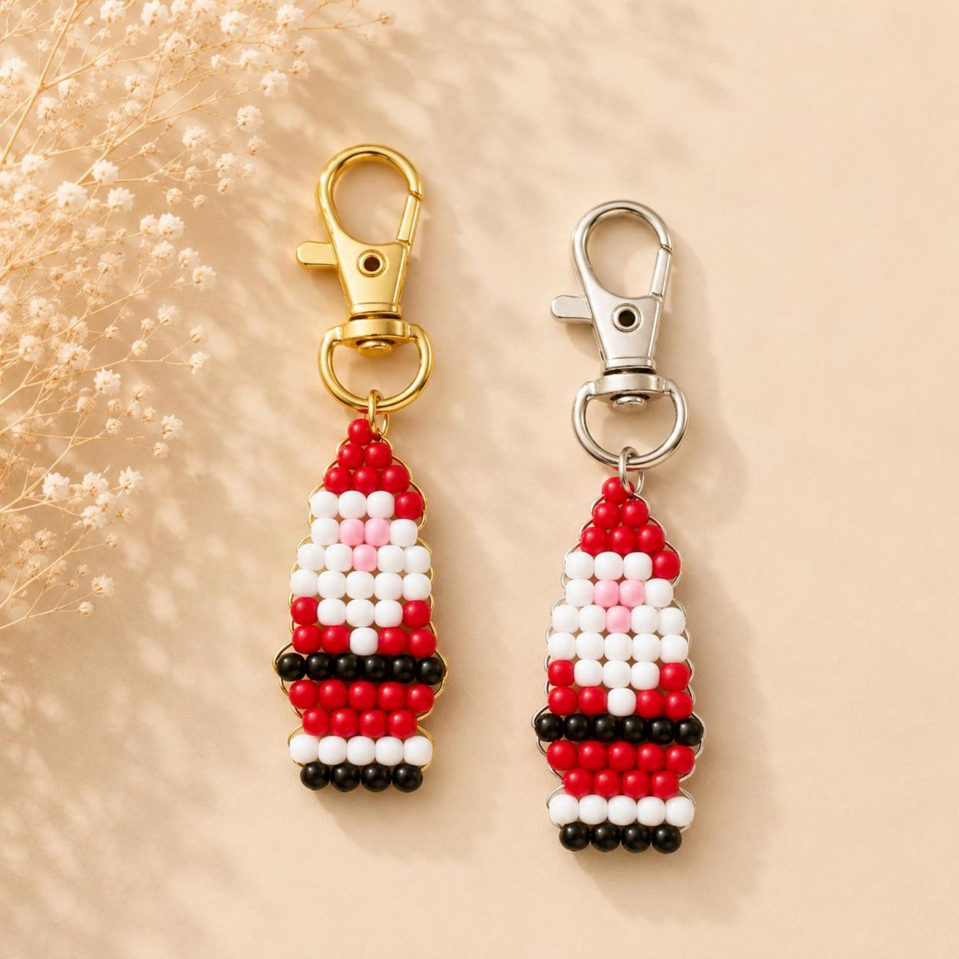 Handmade Santa Claus keychain with red, white, black, and pink glass beads and silver clasp
