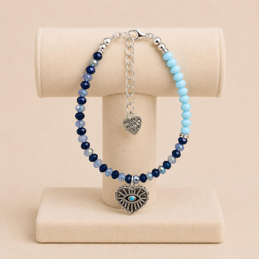Oceanic Opulence handmade bracelet with blue glass beads, silver rhinestone spacers, and heart charm