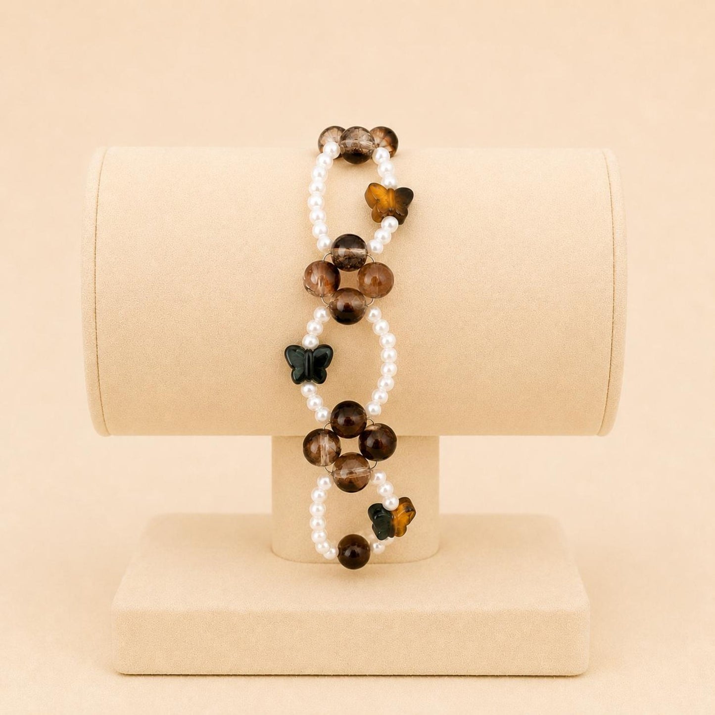 Butterfly Earth Harmony stretch bracelet with white faux pearls, brown glass beads, and crystal butterfly beads on elastic band