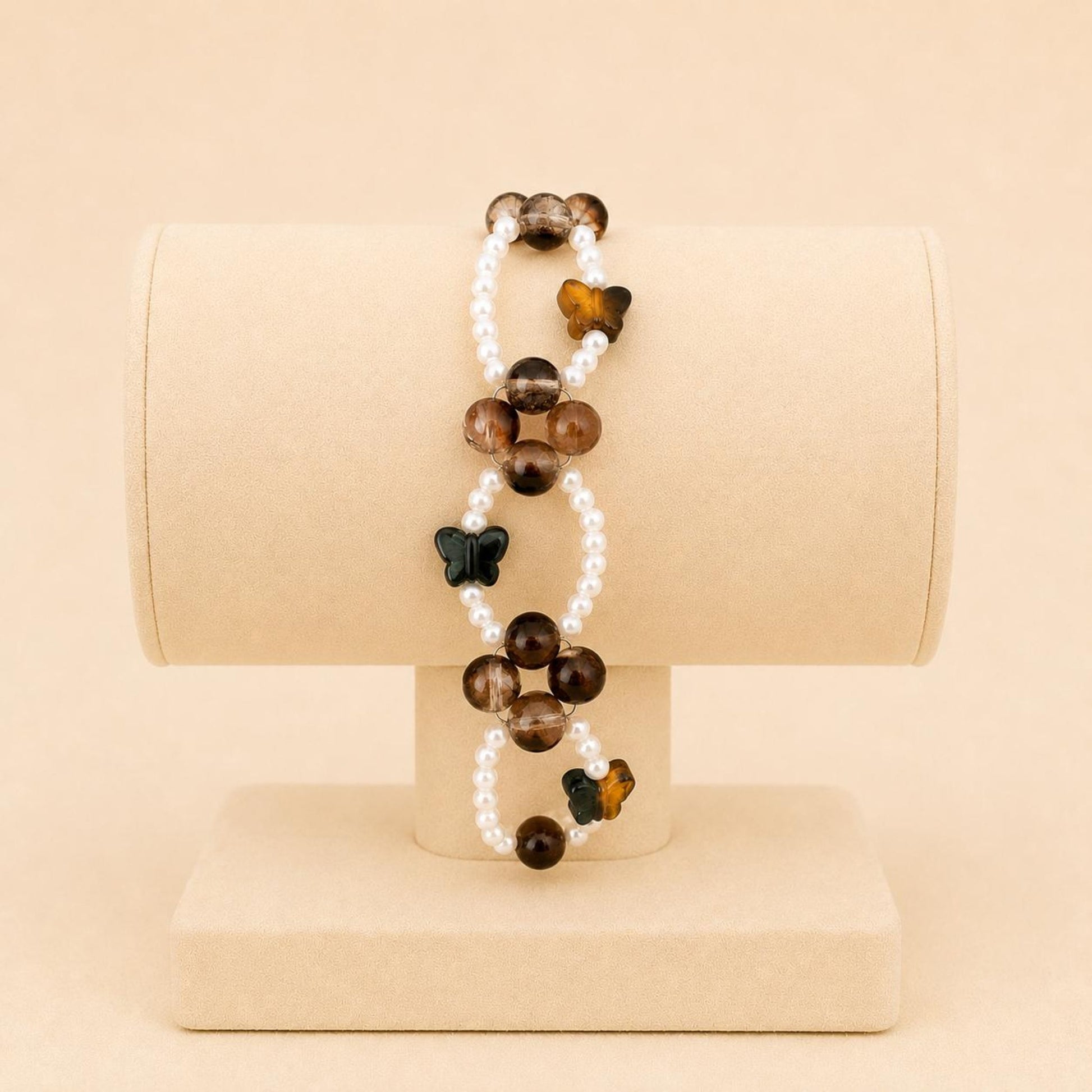 Butterfly Earth Harmony stretch bracelet with white faux pearls, brown glass beads, and crystal butterfly beads on elastic band