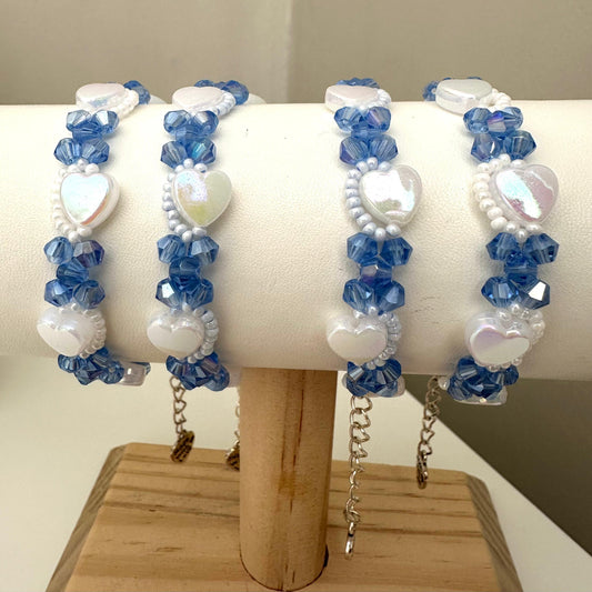 PURE HEART handmade bracelet with blue crystal and white heart-shaped beads, stainless steel clasp, and adjustable nylon string