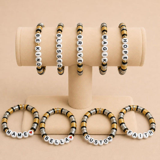 Personalized stretch bracelet with gold, silver, and black beads and customizable letter charms
