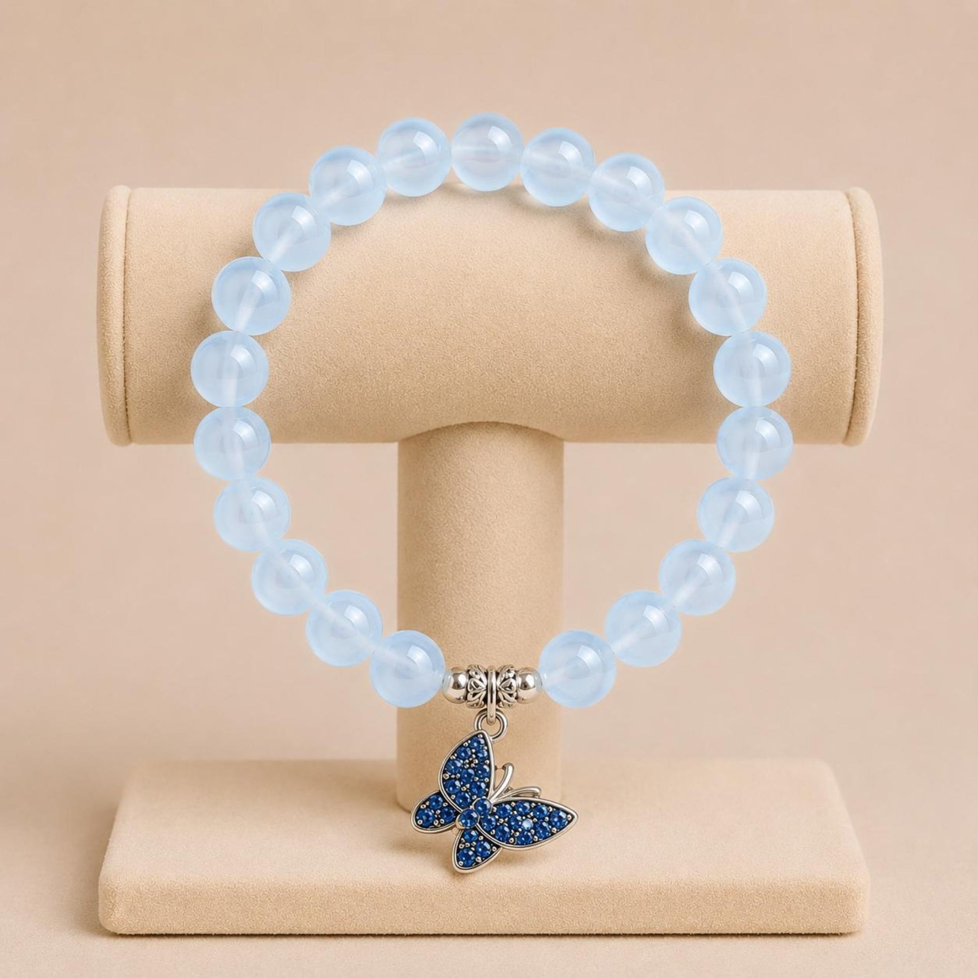 FREEDOM stretch bracelet with blue glass beads, silver spacers, and butterfly charm on elastic band