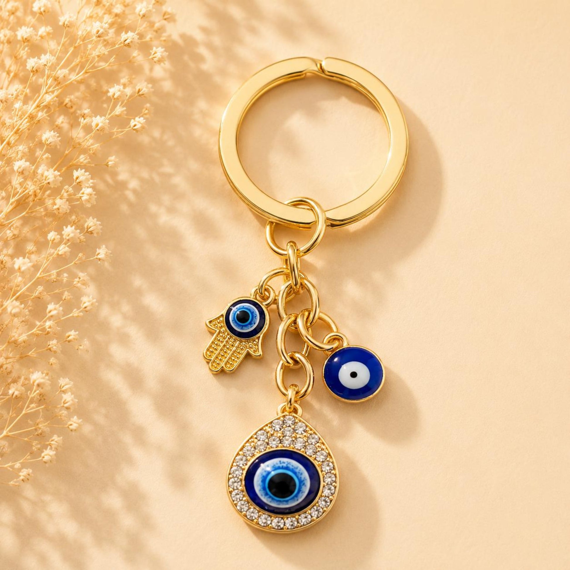 Handmade EVIL EYE golden keychain with three protective charms, 6 cm compact size, stylish and meaningful accessory