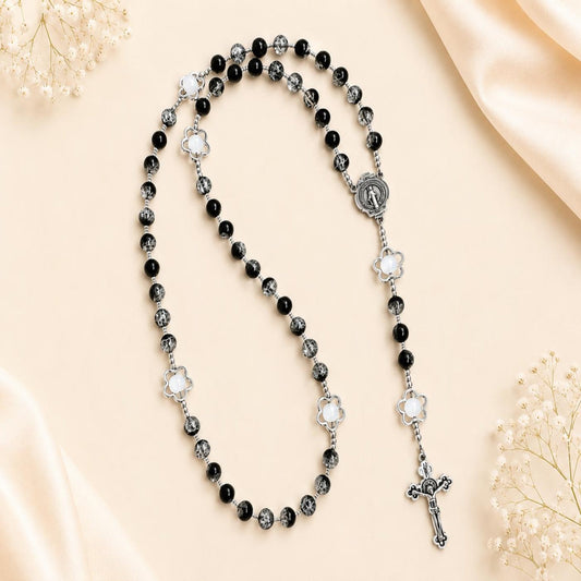 Midnight Bloom Handmade Rosary with black glass beads and silver-tone flower accents on a wooden background
