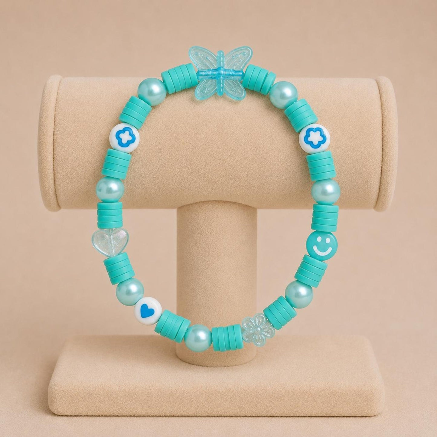 AQUA BREEZE stretch bracelet with blue polymer clay beads, iridescent faux pearls, and flower-shaped acrylic beads on elastic band