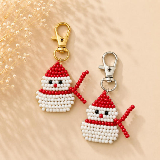 Handmade snowman keychain with red, white, and black beads and silver clasp