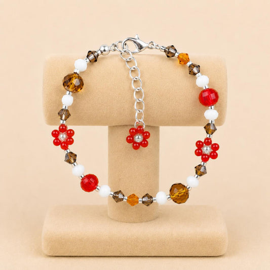 Handmade BRIGHT ESSENCE bracelet with white, brown, orange, red, and beige glass beads and floral accents