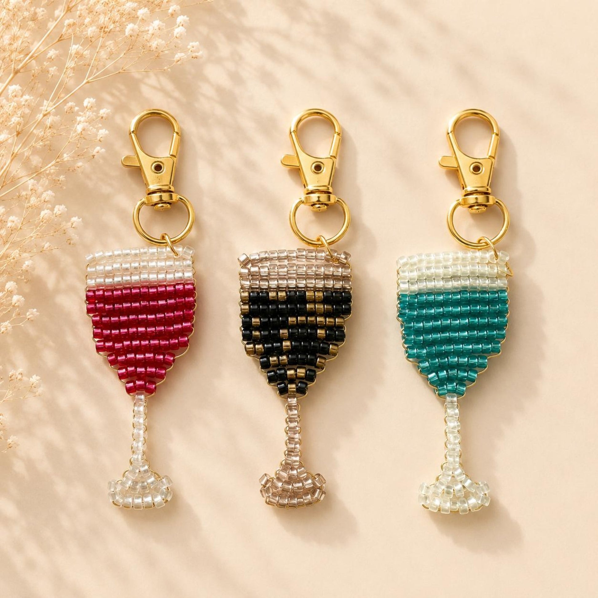 Handmade beaded champagne glass keychain with gold clasp in red, black, or green beads