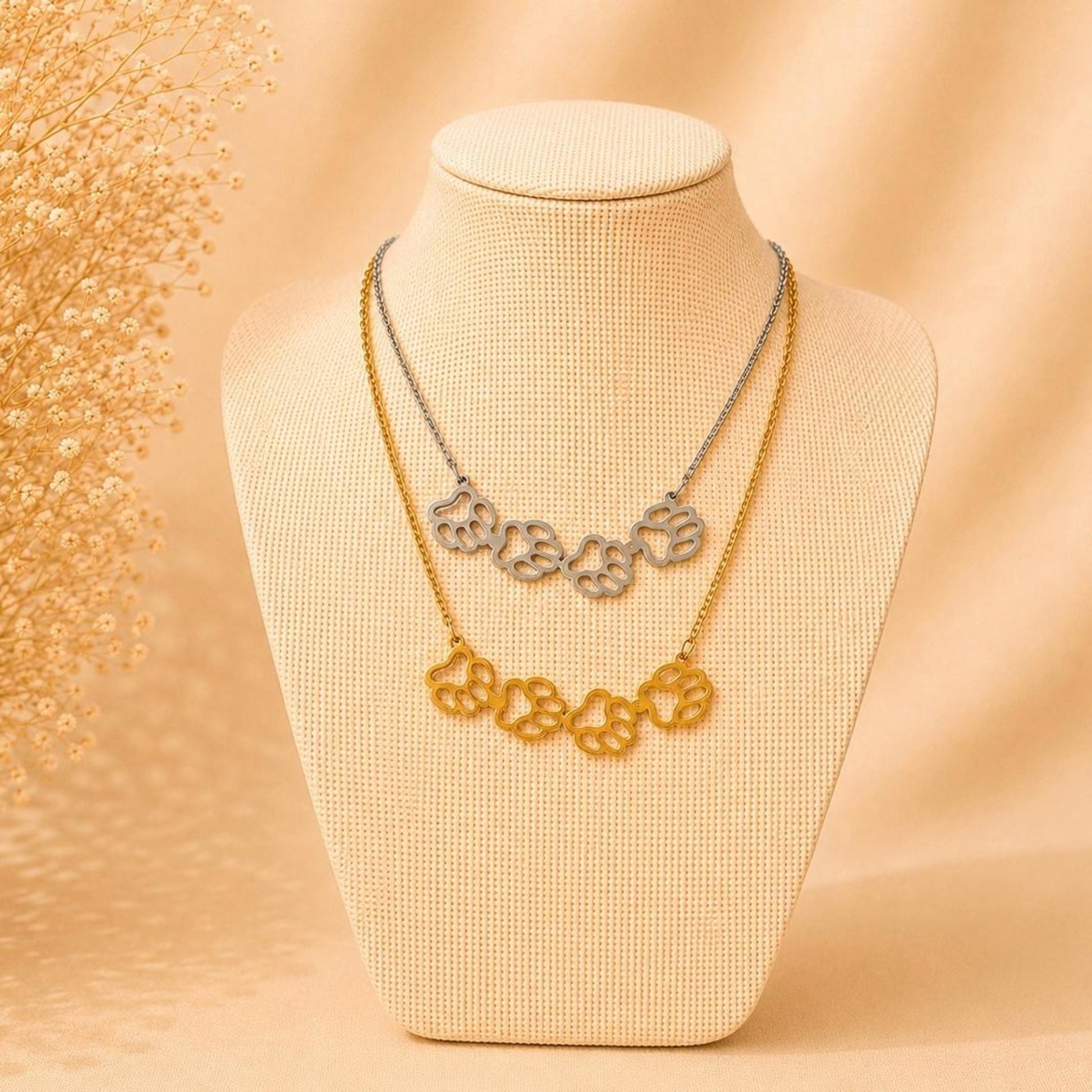 Elegant stainless steel necklace with four paw print pendant in gold and silver, 45 cm length, waterproof and tarnish-resistant.