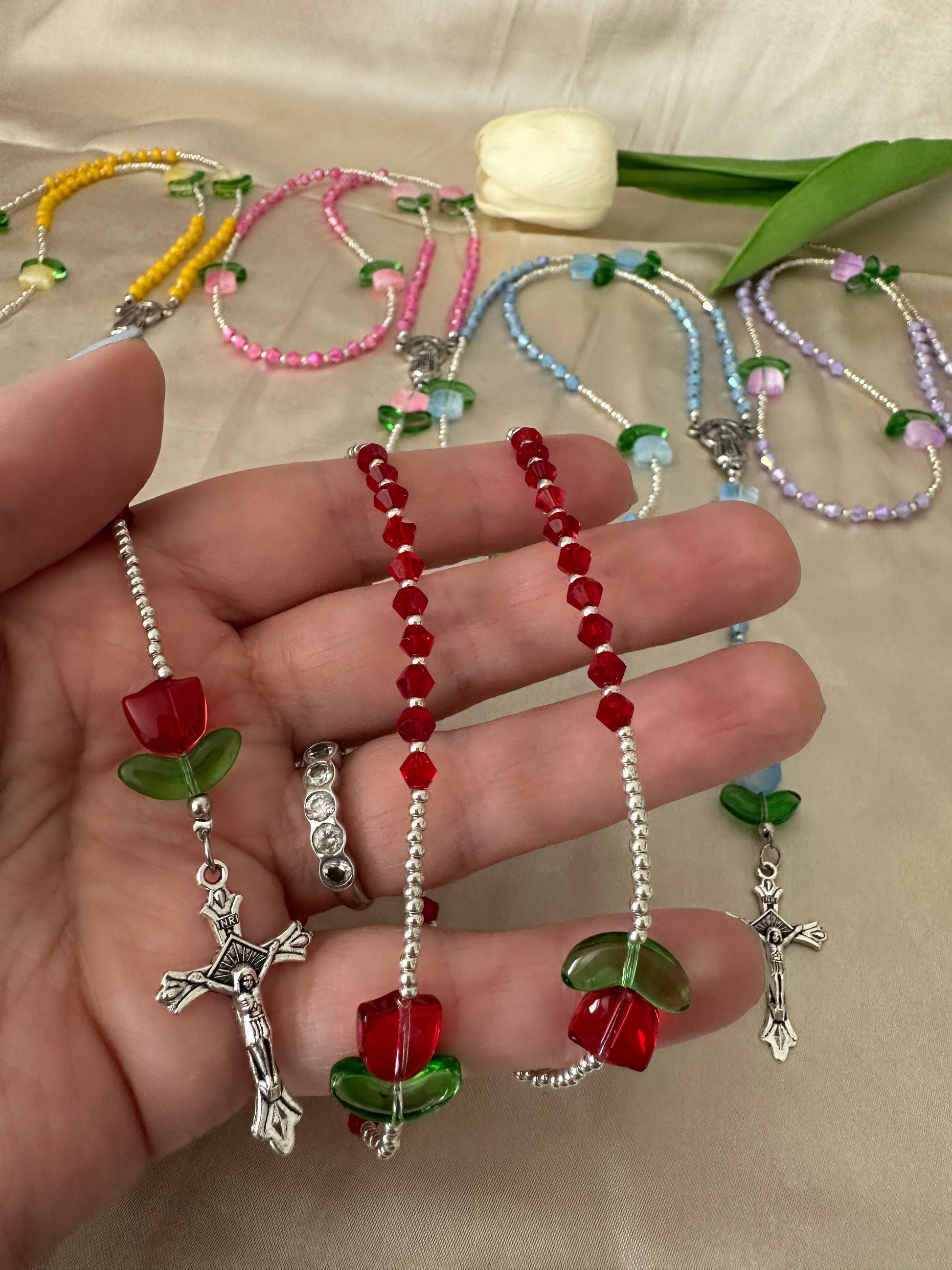 Handmade Blooming Faith rosary with colorful glass beads, acrylic flower accents, and silver crucifix