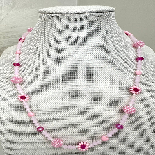 Blush tone handmade necklace with pink and fuchsia glass beads, faux pearls, and floral details on stainless steel chain