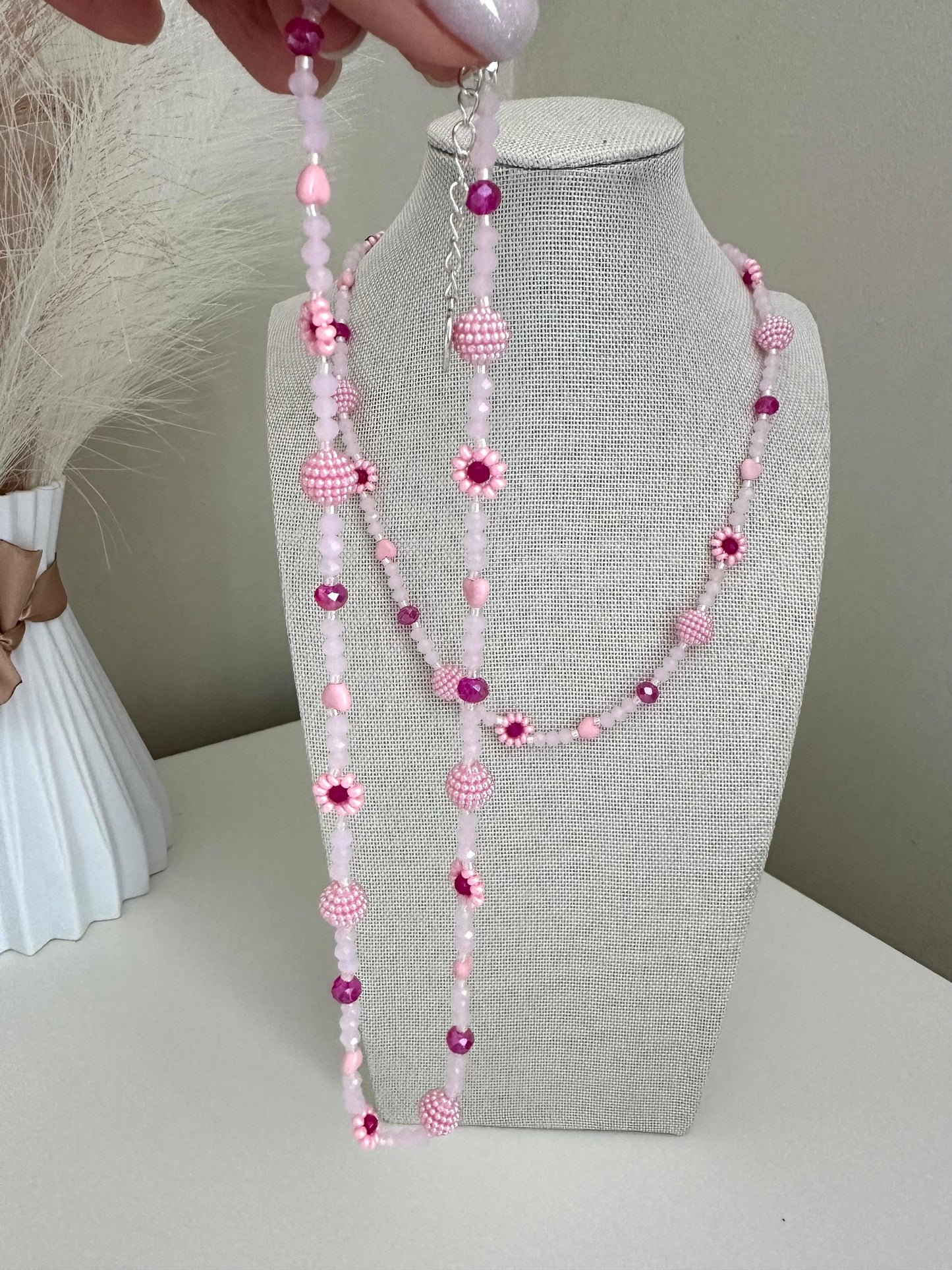 Blush tone handmade necklace with pink glass beads, faux pearls, and floral bead details on stainless steel chain
