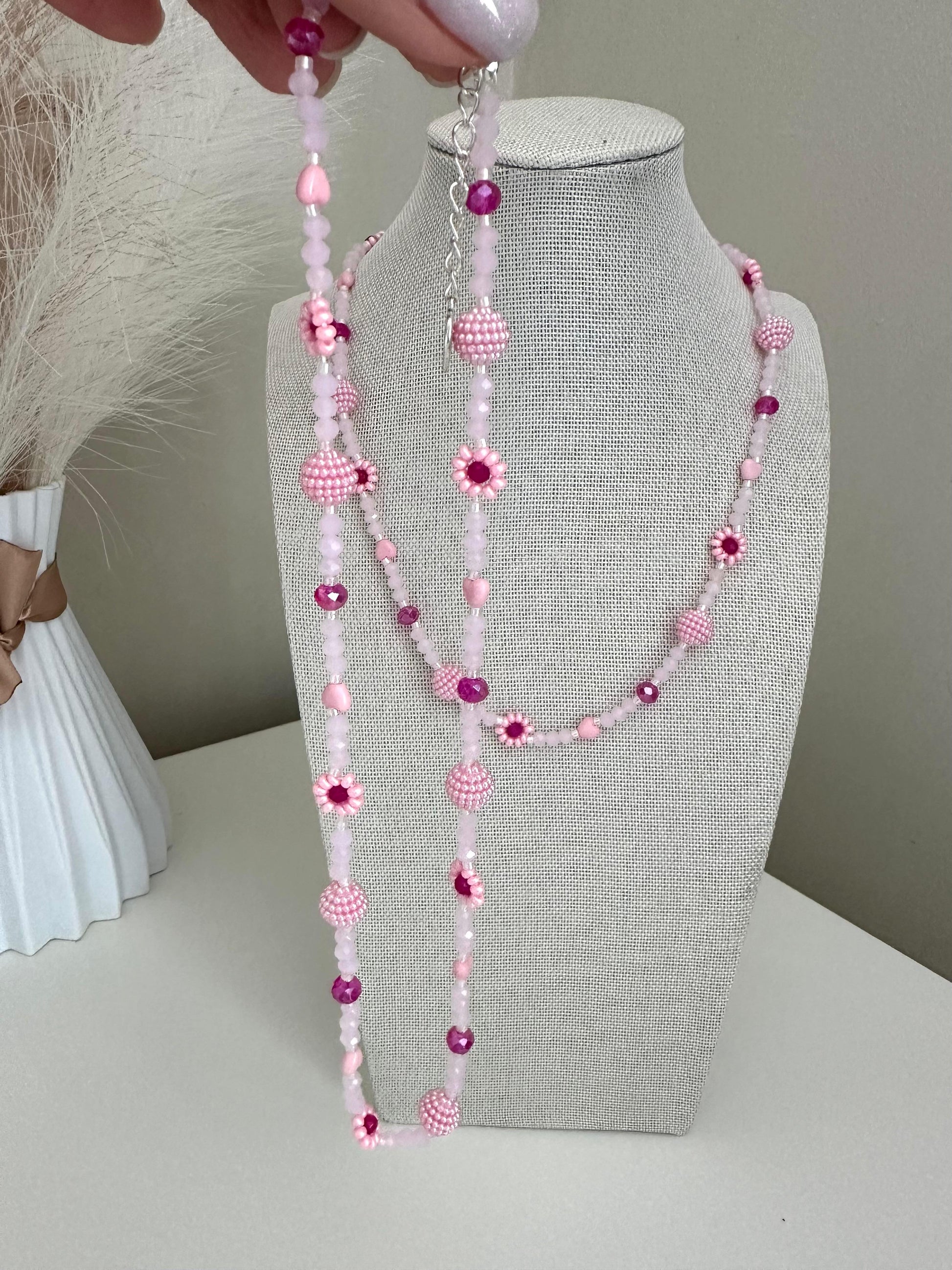 Blush tone handmade necklace with pink glass beads, faux pearls, and floral bead details on stainless steel chain